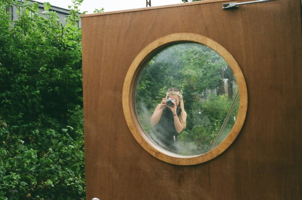 Creative self-portrait through a porthole mirror